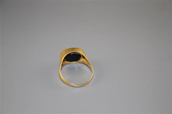 A 1970s 18ct gold, pave set diamond and black onyx set swivel head signet ring, size V, gross weight 8.5 grams.